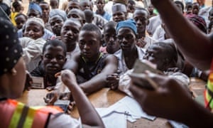 Using a fingerprint reader at a polling station in Abuja – problems with technology forced a 24-hour extension to the election.