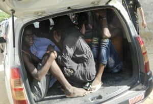 Students of the Garissa University College take shelter in a vehicle after fleeing the attack.