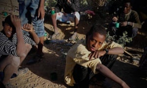 Teenage Eritrean migrants fleeing their country’s harsh  compulsory recruitment policy rest in Ethiopia after crossing the border.