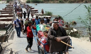 Sunnis flee Ramadi west of Baghdad this month. The Iraqi city is at risk of falling under Isis control.