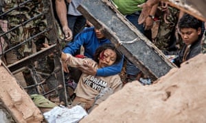 A woman is rescued from the ruins of the 19th-century Dharahara Tower in Kathmandu