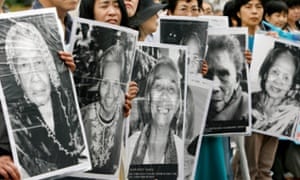 Japanese women hold portraits of Chinese, Philippine, South Korean and Taiwanese women forced into Japanese military brothels during the Second World War