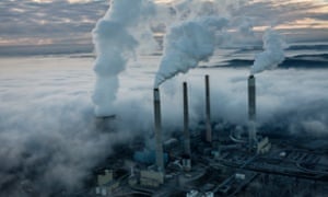 Steam and smoke rise from the cooling towers and chimneys of a power plant in West Virginia.