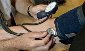 Doctor checks patient's blood pressure