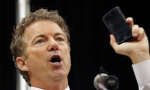 Rand Paul holds up his cellphone to make a point about NSA surveillance.