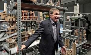 Chris Burden with his kinetic sculpture Metropolis II (2011), which circulates thousands of cars through a network of tracks in a complex model city. Photograph: Jae Hong/AP