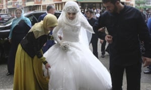 Chechen Kheda Goilabiyeva, is taken by head of the Chechen leader's administration Magomed Daudov to a wedding registry office for her wedding with Chechen police officer Nazhud Guchigov, in Chechnya's provincial capital Grozny, Russia, Saturday, May 16, 2015.