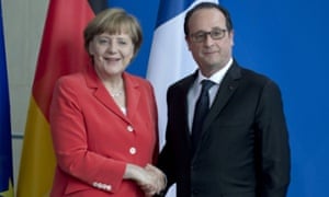 Angela Merkel and François Hollande shake hands in Berlin.