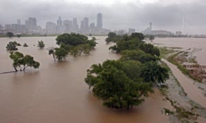 The Trinity river floods the area below the Sylvan Avenue bridge on 25  May 25, with downtown Dallas. in the background.
