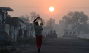 A migrant laborer carries a bottle of water in the Dwarka sector of New Delhi. A UN report released in March warned of an urgent need to manage the world’s water more sustainably and said too much groundwater is being extracted in India and China.