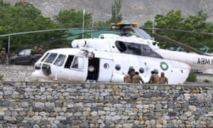 Pakistani soldiers gather beside an army helicopter at a military hospital where victims of a helicopter crash were brought for treatment in Gilgit.