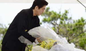 Japanese prime minister Shinzo Abe lays a bouquet of flowers during a memorial service to mark the 70th anniversary of the Battle of Okinawa.