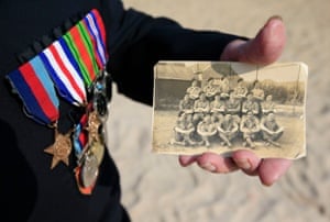 <strong>Sword Beach, France </strong>Normandy veteran Alan King, from the Norwich and District NVA, holds a photo of himself (front second left) and his comrades from B Company taken on VE Day 1945, as dozens of British veterans made a cross-Channel pilgrimage to Normandy to honour the legacy of comrades killed in the D-Day landings 71 years ago.