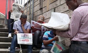 Ethiopian people read newspapers a day before the country goes into a general election in capital Addis Ababa
