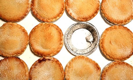 MInce pies surrounding an empty foil container for an already eaten mince pie