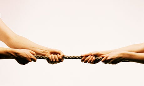 Two sets of hands pulling a rope in opposite directions.
