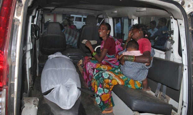 A woman is mourned as her body lies in the back of a van after botched sterilisation surgery in Chhattisgarh, India.
