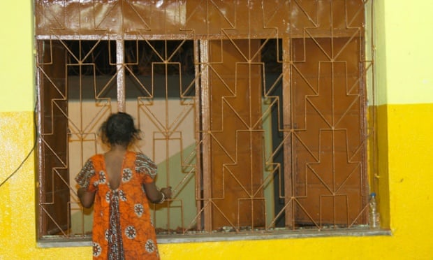 A woman with a disability stands at the window of a night shelter run by Iswar Sankalpa, a Kolkata-based NGO, where women receive food, basiccare, and access to voluntarytreatment until they are ready to go back to their communities.