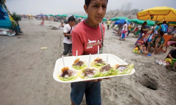 A boy sells servings of ceviche at Agua Dulce beach in Lima.