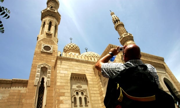 Tourist photographing Jumeirah mosque, Dubai, UAE.