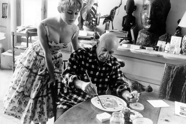 Brigitte Bardot watching Pablo Picasso at work in his studio in Vallauris during the 1956 International Cannes film festival.