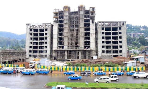 Traffic passes a street with buildings under construction in Addis Ababa
