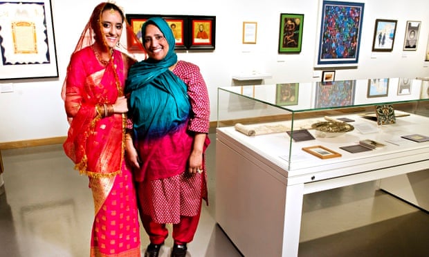 Tahnia Ahmed, left, models the wedding sari of her mother Hasna Hena at the Jewish Museum