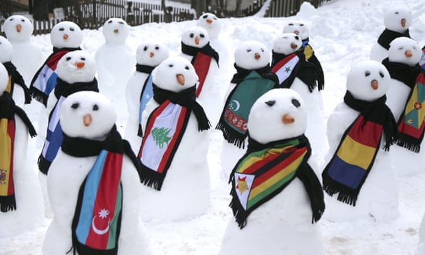 Snowmen decked out in various country flag scarfs, in Davos, Switzerland during the World Economic Forum on 23 Jan 2015.