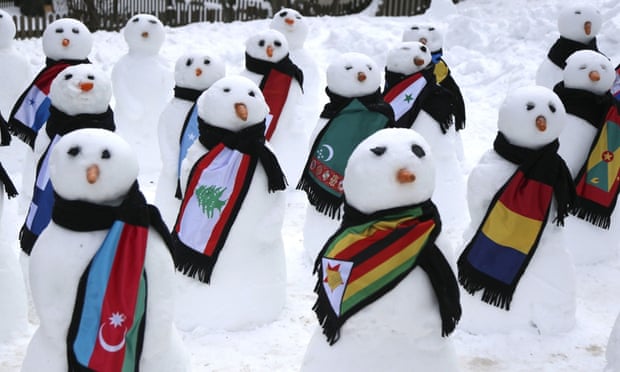 Snowmen decked out in various country flag scarfs, in Davos, as part of a climate change protest.