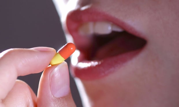 Woman takes a pill, Symbolic picture for: Medicine, medicine costs, pharmaceutics.