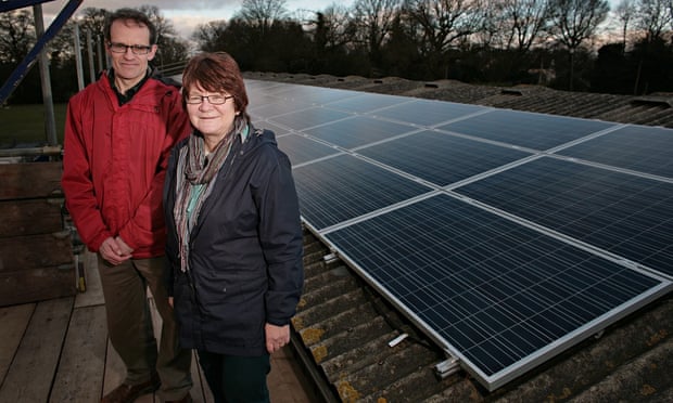 REPOWERBalcombe members Tom Parker and Jackie Emery next to the solar panels on Grange Farm cow shed