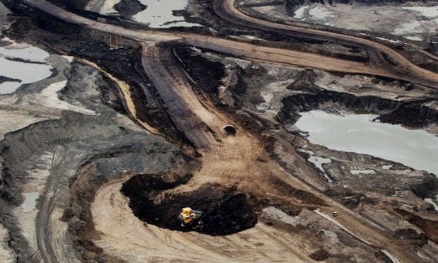 The Syncrude Canada Ltd. mine is seen in this aerial photograph taken above the Athabasca Oil Sands near Fort McMurray, Alberta, Canada, on June 19, 2014.