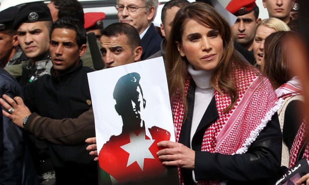 Queen Rania of Jordan holds a picture of the murdered pilot Muadh al-Kasasbeh at a march against Isis in Amman. 