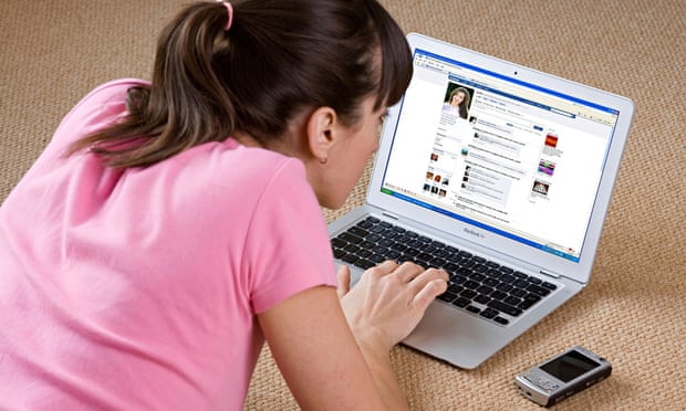 young woman looking at Facebook website on laptop computer. Image shot 2008. Exact date unknown.