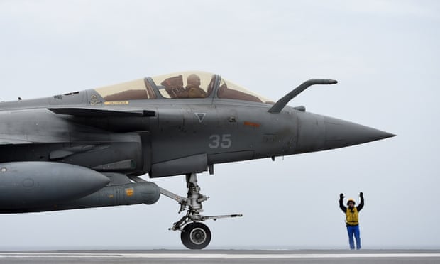 A French Rafale fighter aircraft landing on the Charles de Gaulle aircraft carrier.