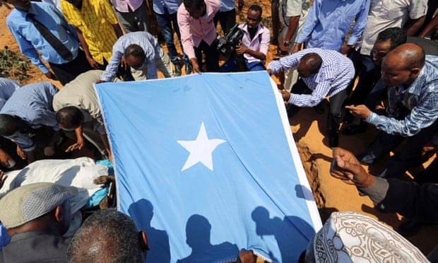 Mourners bury the Somali MP Abdullahi Qayad Bare, who was shot dead in Mogadishu by al-Shabaab gunmen in February.