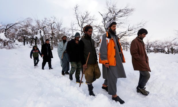 Relatives of avalanche victims return after conducting a search for the victims in Panjshir.