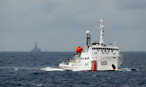 A Chinese Coast Guard vessel passes near the Chinese oil rig, Haiyang Shi You 981 in the South China Sea, about 210 km (130 miles) from the coast of Vietnam. The US says it is concerned at China’s aggressive exertion of sovereignty in the sea.