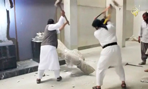 Men use sledgehammers on a toppled statue in a museum at a location said to be Mosul