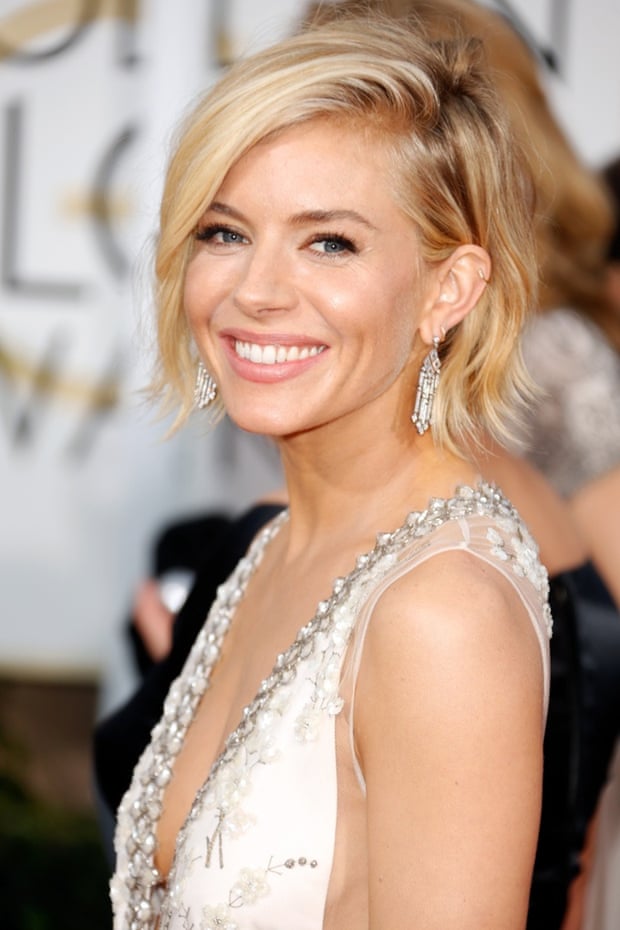 Fabulous earrings ... Sienna Miller at the Golden Globes. Photograph: Jeff Vespa/WireImage
