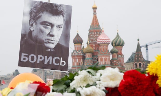 A portrait of murdered Russian opposition veteran leader Boris Nemtsov above floral tributes near St Basil's cathedral in Moscow.