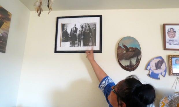 Janice at home, showing family pictures.
