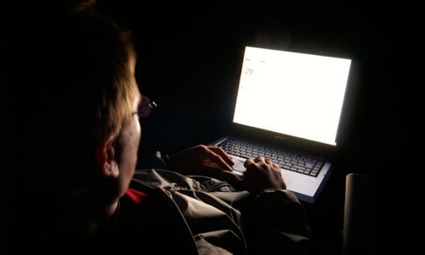 A man uses a laptop.