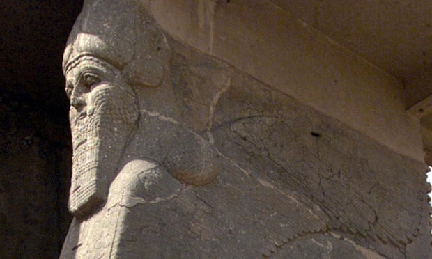 An ancient statue of a winged bull with a human face.
