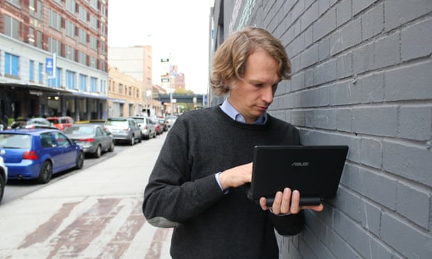 A man uploads information from a USB Dead Drop in New York City.