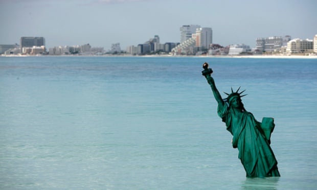 A cardboard version of the Statue of Liberty stands in the ocean at the Gaviota Azul beach in Cancun December 8, 2010. Greenpeace staged a performance sinking the world's best known landmarks in the ocean as climate talks take place in the beach resort.