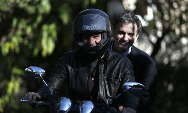 Greek finance minister, Yanis Varoufakis , drives his motorcycle with deputy foreign minister for international economic relations, Euclid Tsakalotos riding pillion.