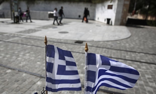 Greek flags flutter in an Athens street as the  government remains locked in strained negotiations with creditors. 