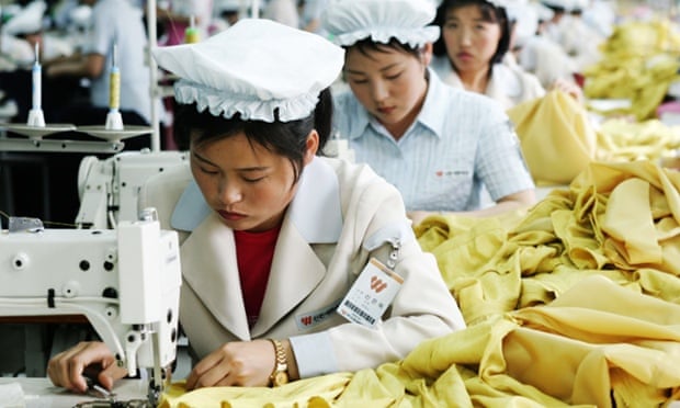 North Korean women wearing white hats work at sewing machines at the assembly line of a textile company  at the Kaesong industrial complex  in North Korea.