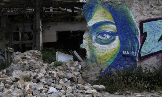 Graffiti by Greek street artist Achilles is seen on a wall of an abandoned house in central Athens, on Wednesday, April 22, 2015.